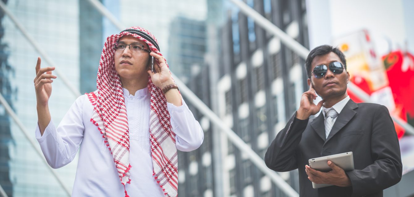 arabic-businessman-looking-tablet-with-his-bodygua-2026-01-11-10-38-01-utc