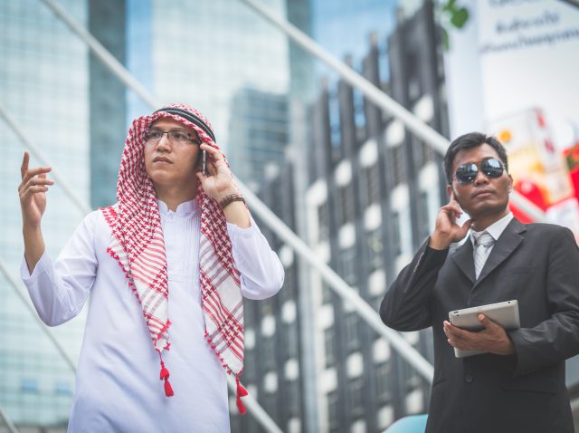 arabic-businessman-looking-tablet-with-his-bodygua-2026-01-11-10-38-01-utc
