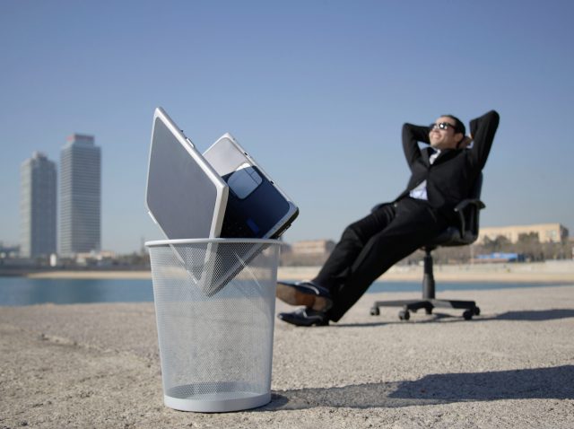Business man sitting by seafront