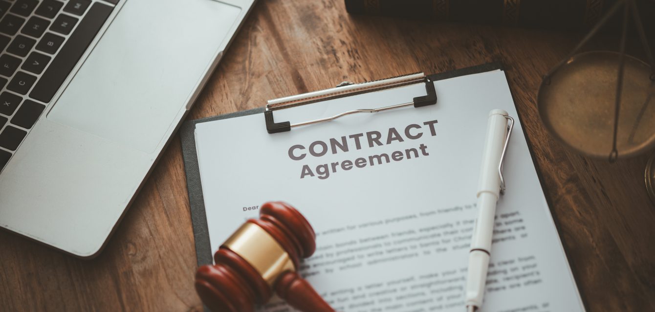 Judge's Hammer and Legal Book on Table - Symbolizing Contract Agreements and Courtroom Proceedings,Law and Justice Concept