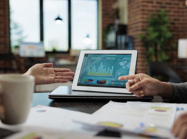 Clsoe up of digital tablet with management graphs on display