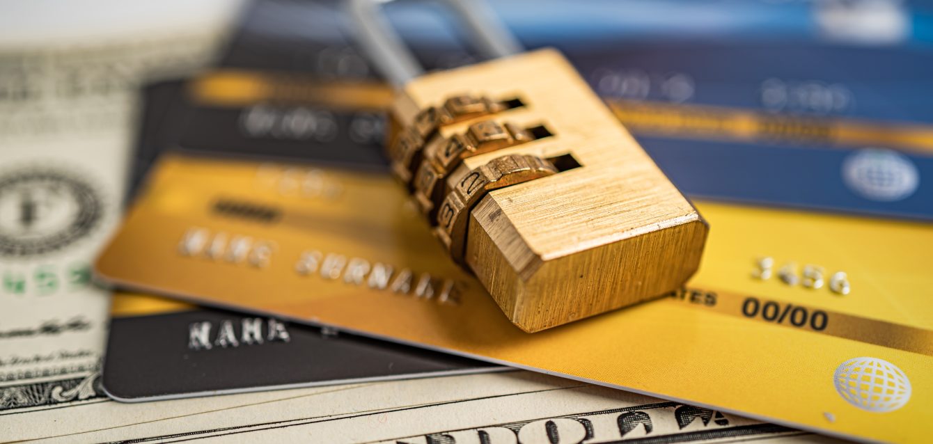 Credit card with password key lock on US dollar background. Credit card with password key lock on US dollar background.