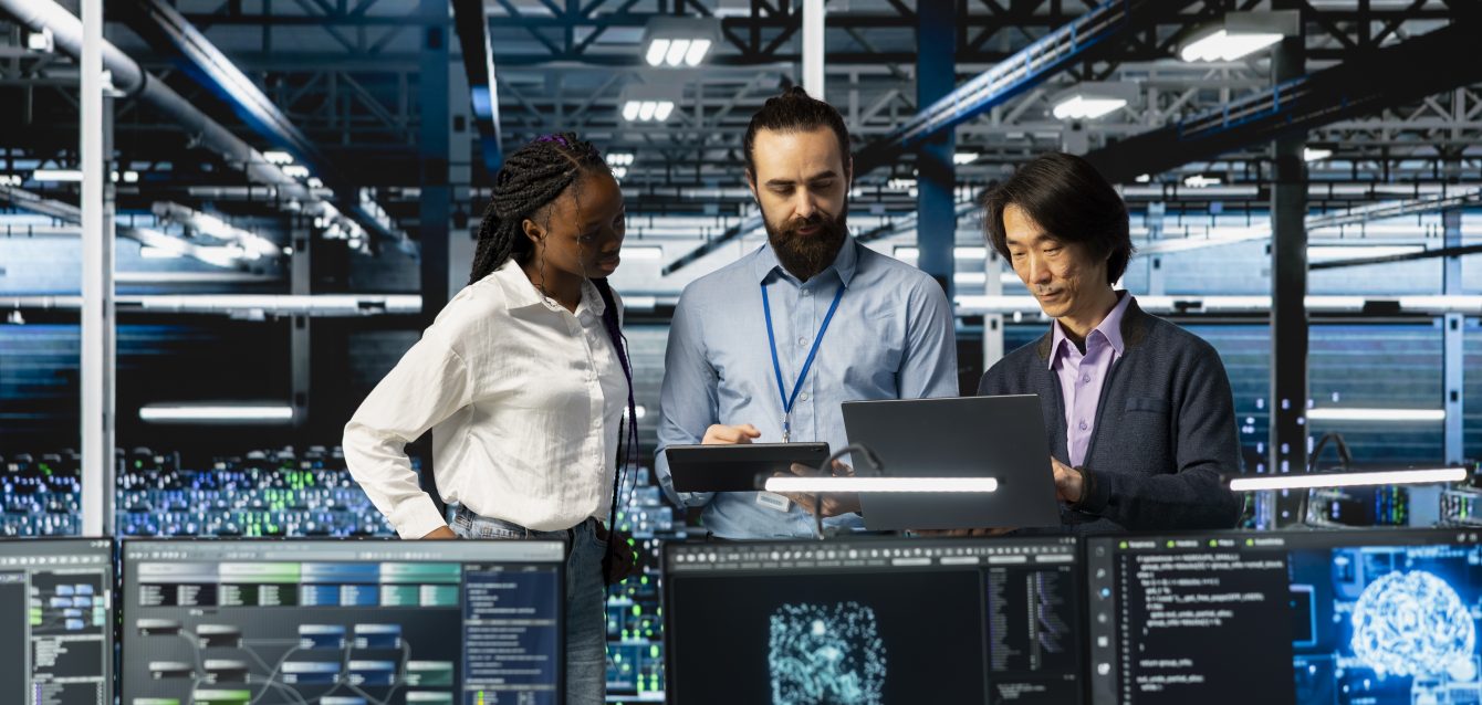 Team of data center coworkers in office running AI forecasting simulations