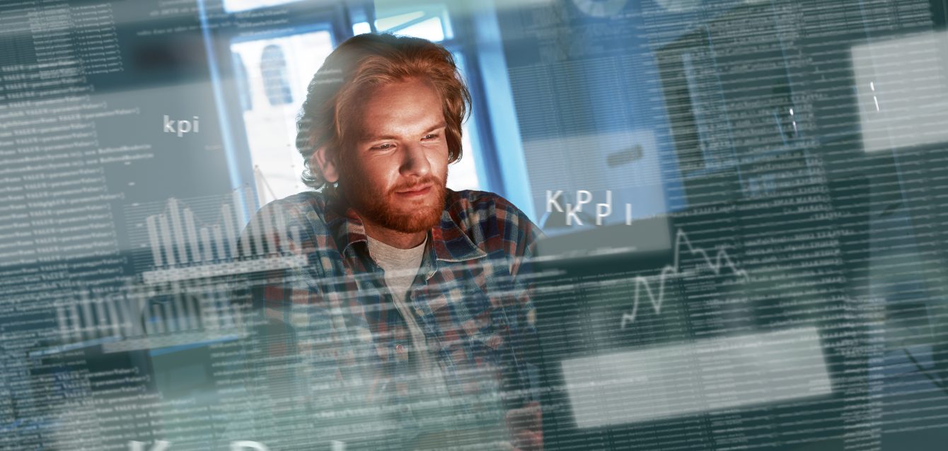 Young concentrated computer developer writing new code