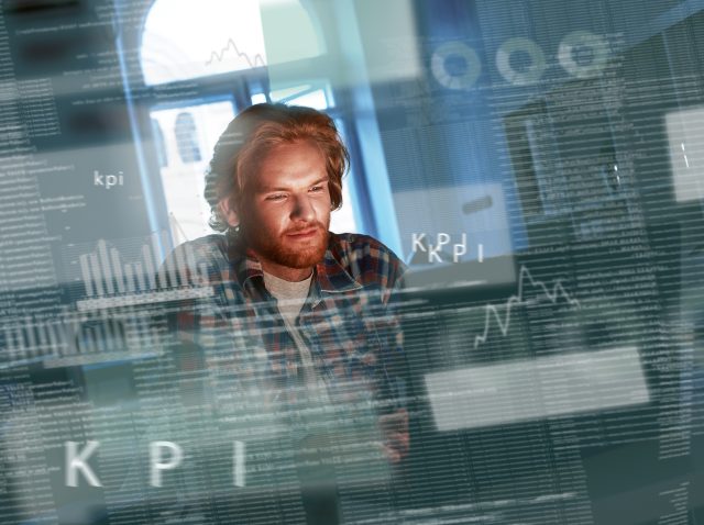 Young concentrated computer developer writing new code