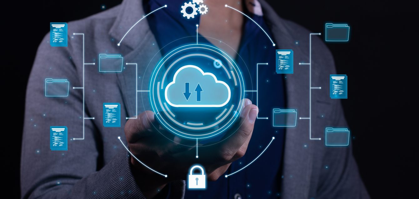 A man employs cloud-based computing on his smartphone to facilitate data transmission, storage, backup, and access