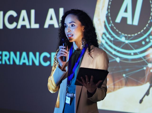 business-speaker-and-woman-at-seminar-with-mic-t-2026-01-09-09-19-41-utc