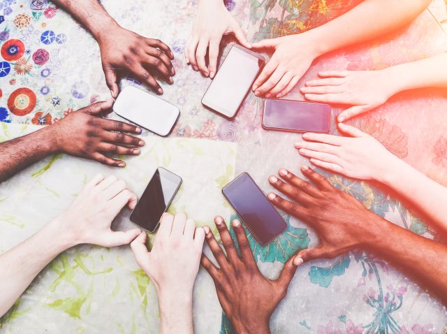 group-of-friends-having-fun-with-smartphones-clo-2026-01-11-08-09-30-utc