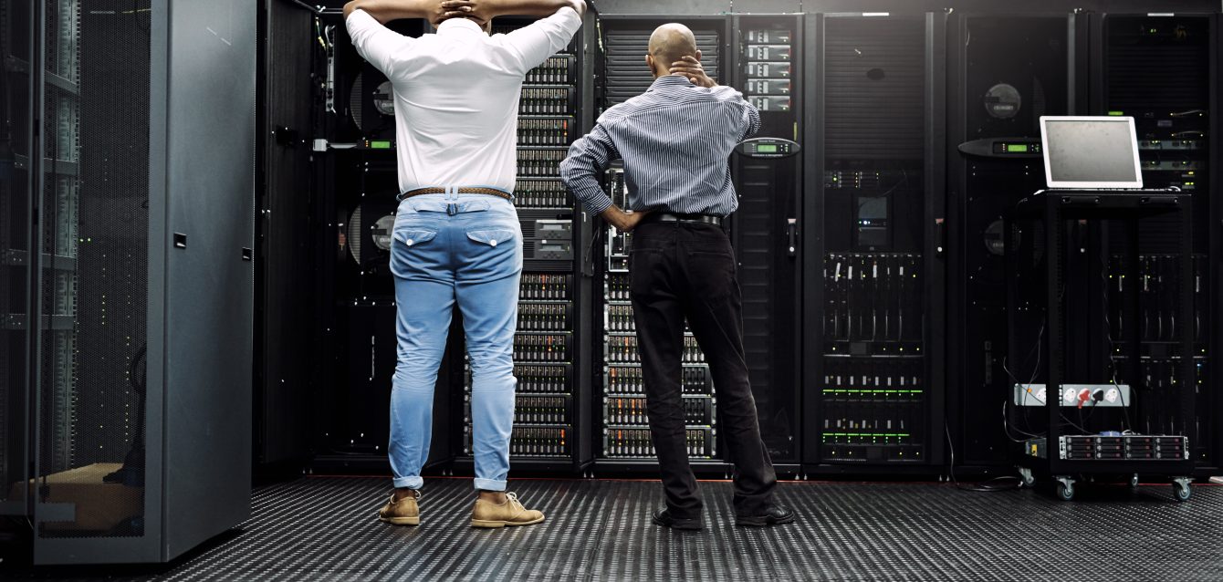 rearview-shot-of-two-it-technicians-having-difficu-2026-01-09-11-20-50-utc