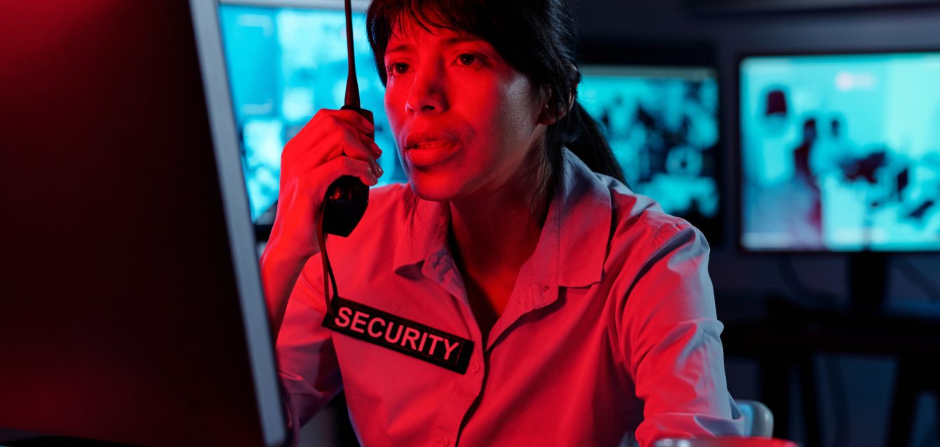 Young female officer using walkie-talkie Young female officer using walkie-talkie