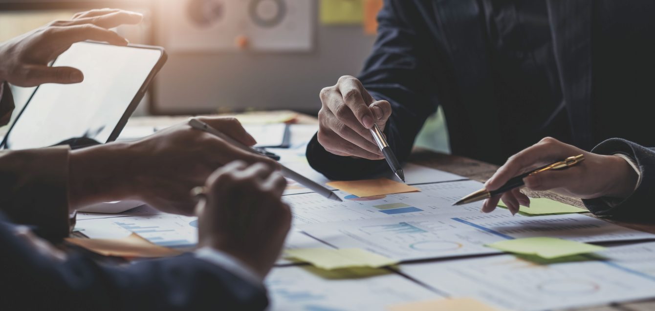 Asian business adviser meeting to analyze and discuss the situation on the financial report in the meeting room.Investment Consultant, Financial advisor and accounting concept Asian business adviser meeting to analyze and discuss the situation on the financial report in the meeting room.Investment Consultant, Financial advisor and accounting concept