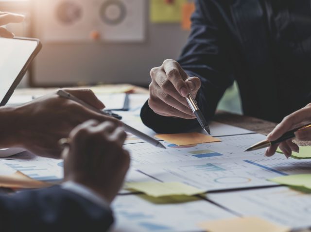 Asian business adviser meeting to analyze and discuss the situation on the financial report in the meeting room.Investment Consultant, Financial advisor and accounting concept Asian business adviser meeting to analyze and discuss the situation on the financial report in the meeting room.Investment Consultant, Financial advisor and accounting concept