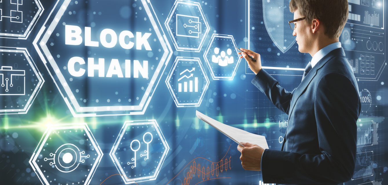 businessman-drawing-abstract-block-chain-hologram-2026-01-11-08-33-49-utc