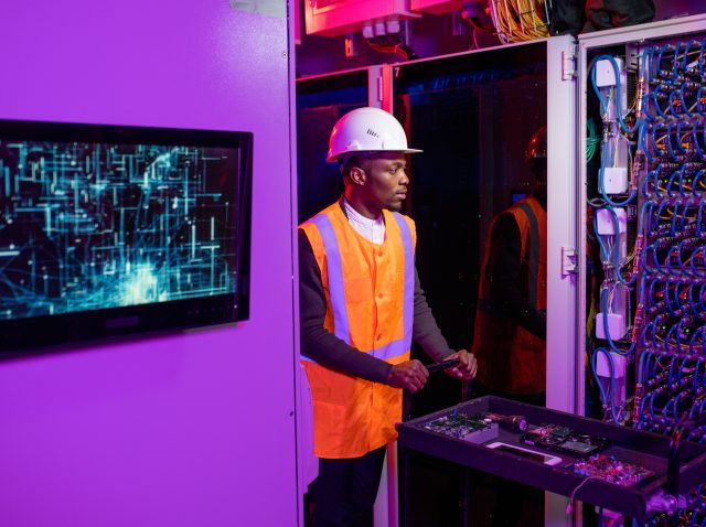 Security System Engineer Pushing Cart with Server Components Security System Engineer Pushing Cart with Server Components